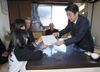 Photograph of the Prime Minister visiting private housing in Watari Town