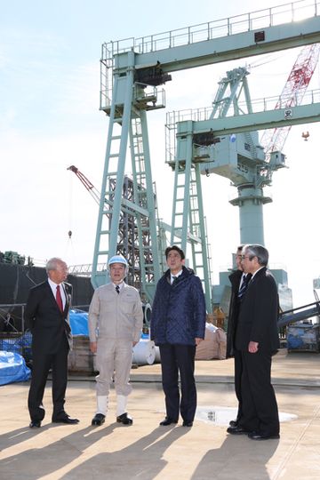 Photograph of the Prime Minister observing a shipyard