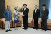 Photograph of the Prime Minister being presented with a <i>kariyushi</i> shirt from the Governor of Okinawa Prefecture