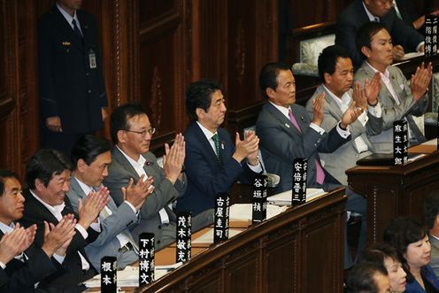 Photograph of the Prime Minister applauding following the re-passage of the Bill to Amend the Public Offices Election Act