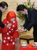 Photograph of Prime Minister Abe being presented with a tea set designed by Ms. Yayoi Kusama