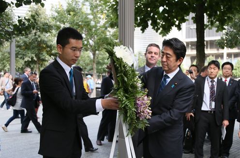 Photograph of the Prime Minister offering flowers at Ground Zero