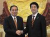 Photograph of Prime Minister Abe shaking hands with H.E. Mr. Choummaly Sayasone, President of the Lao People's Democratic Republic