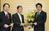Photograph of Prime Minister Abe receiving the resolution from Mr. Masahiko Komura, President of the Strategic Council on Rebuilding Diplomacy of the Liberal Democratic Party