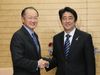 Photograph of Prime Minister Abe shaking hands with H.E. Dr. Jim Yong Kim, President of the World Bank
