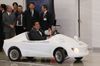 Photograph of the Prime Minister test-driving a small-scale electric vehicle (EV) (2)