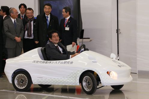 Photograph of the Prime Minister test-driving a small-scale electric vehicle (EV) (2)