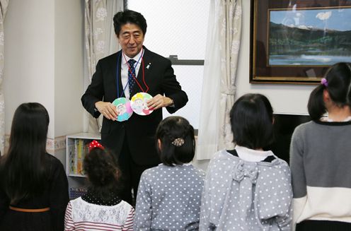 Photograph of the Prime Minister receiving handmade medals as a present