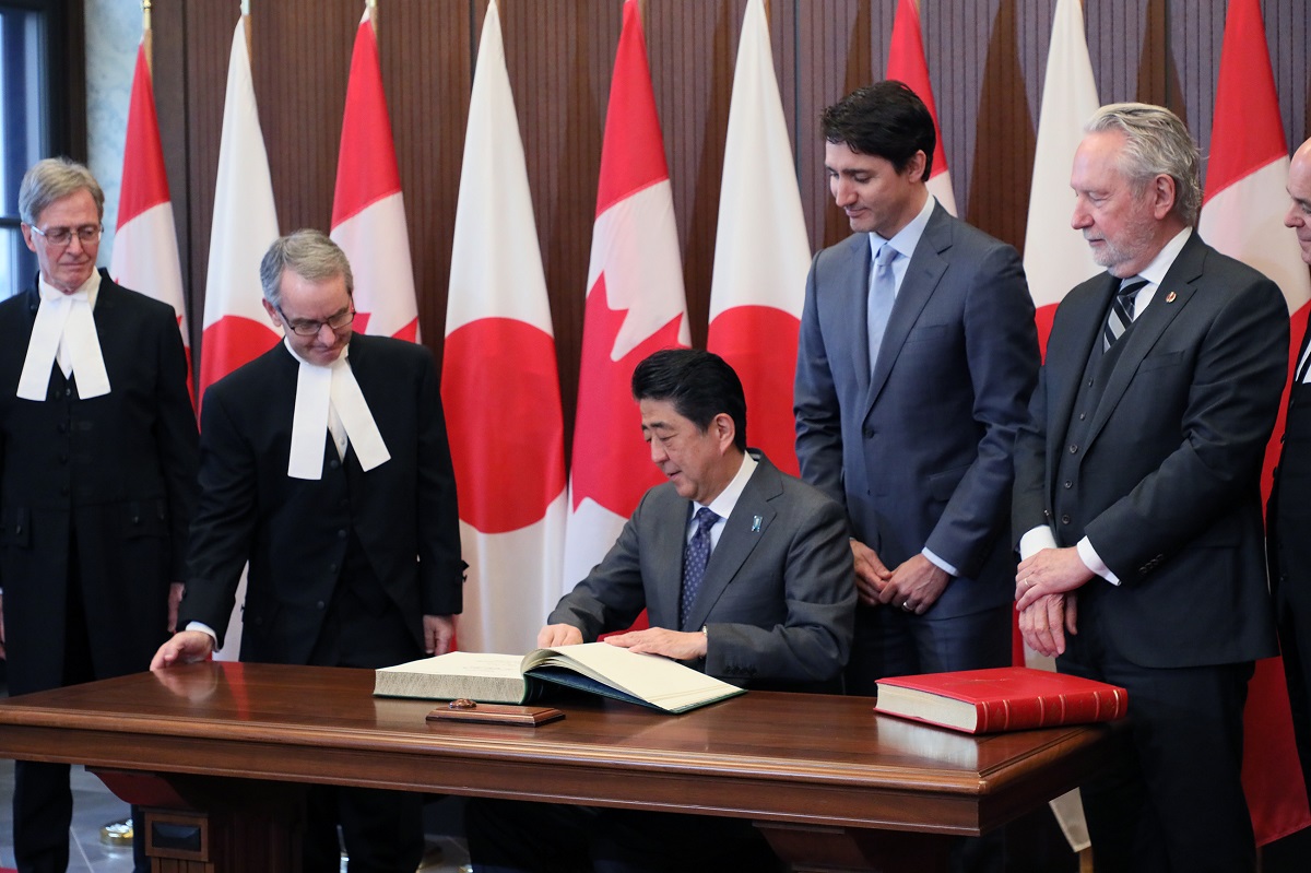 Photograph of the Prime Minister signing a book prior to the summit meeting (1)