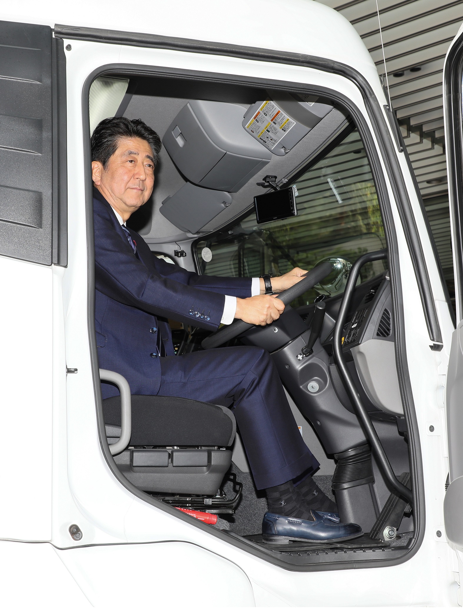Photograph of the Prime Minister riding in a truck (1)