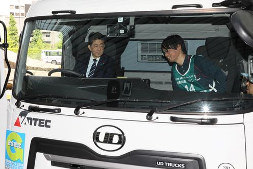 Photograph of the Prime Minister riding in a truck (2)