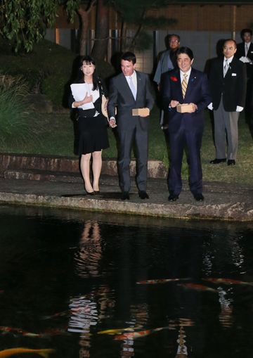 Photograph of the leaders feeding the carp at a Kyoto State Guest House  pond