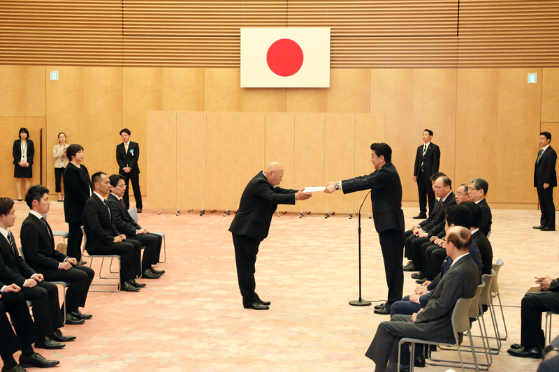 Photograph of the Prime Minister presenting a certificate of appreciation
