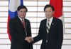 Photograph of Prime Minister Hatoyama shaking hands with Prime Minister Bouasone of the Lao People's Democratic Republic