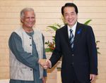 Photograph of the Prime Minister shaking hands with President of Grameen Bank Muhammad Yunus