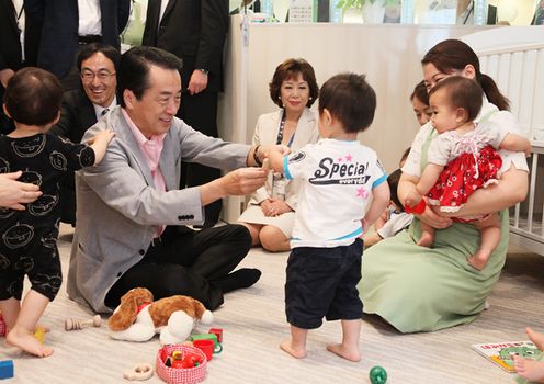 Photograph of the Prime Minister interacting with children at an in-house nursery school