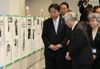 Photograph of the Prime Minister viewing photos with the guidance of Mr. Shigeru Yokota and his wife 3