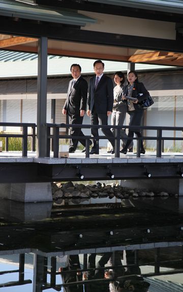 Photograph of the leaders taking a stroll across the courtyard of the Kyoto State Guest House