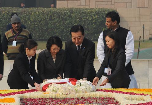 Photograph of Prime Minister and Mrs. Noda offering flowers at Raj Ghat