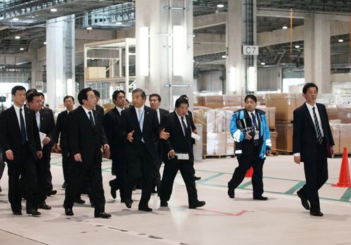 Photograph of the Prime Minister observing Naha Airport's new cargo terminal