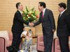 Photograph of the Prime Minister shaking hands with a user of assistance dogs for physically disabled persons