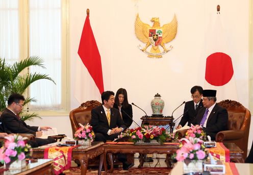 Photograph of the Prime Minister at the meeting among a small group of people
