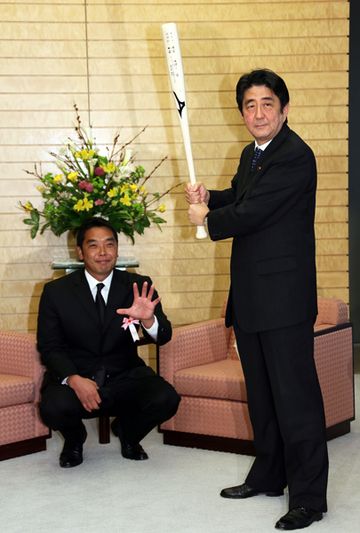 Photograph of the Prime Minister gripping the bat presented as a commemorative gift