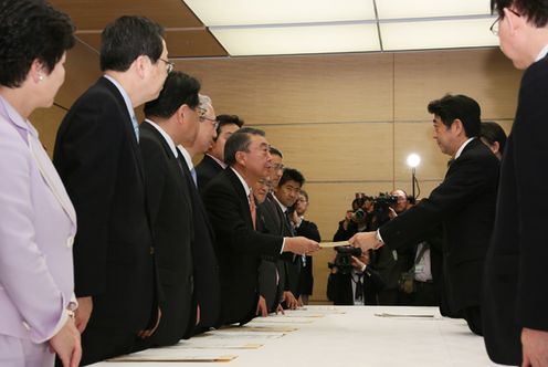 Photograph of the Prime Minister receiving a proposal on a request for accelerating reconstruction from the Great East Japan Earthquake