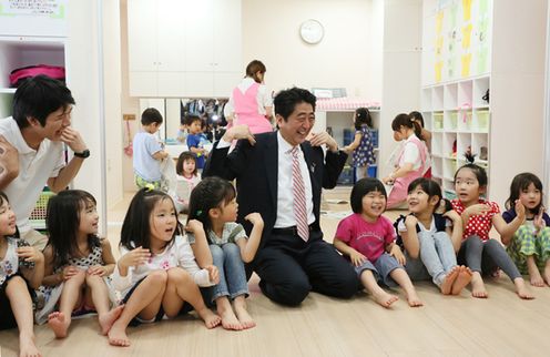 Photograph of the Prime Minister interacting with children and others