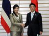 Photograph of Prime Minister Abe shaking hands with Prime Minister Yingluck Shinawatra of the Kingdom of Thailand