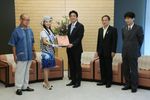 Photograph of the Prime Minister being presented with a <i>kariyushi</i> shirt from the Governor of Okinawa Prefecture
