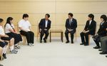 Photograph of Prime Minister Abe receiving a courtesy call from the President of Ashinaga, Mr. Yoshiomi Tamai, recipients of Ashinaga scholarships, and others (1)