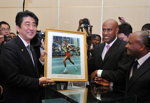 Photograph of the Prime Minister conversing with the son of late Olympian Abebe Bikila
