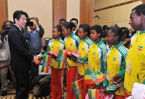 Photograph of the Prime Minister conversing with Ethiopian athletes