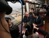 Photograph of the Prime Minister conversing with passengers in a railcar of the Sanriku Railway (1)