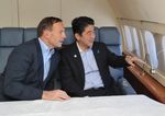 Photograph of the two leaders conversing on board an Australian Government aircraft