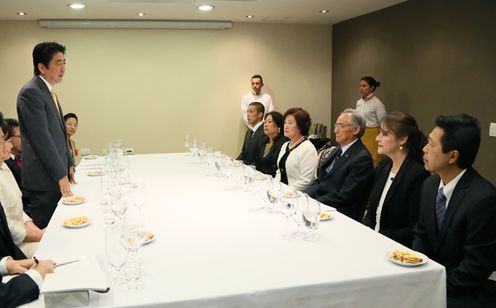 Photograph of the Prime Minster conversing with Japanese-Colombians