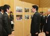 Photograph of the Prime Minister receiving an explanation on the state of activities while viewing a display panel.