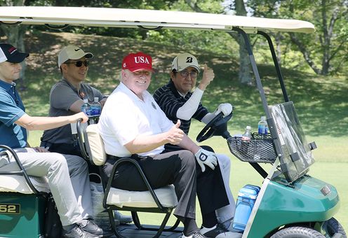 Photograph of the leaders playing golf (2)