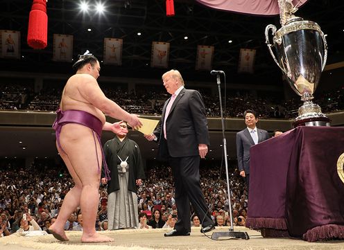 Photograph of President Trump conferring a certificate of award