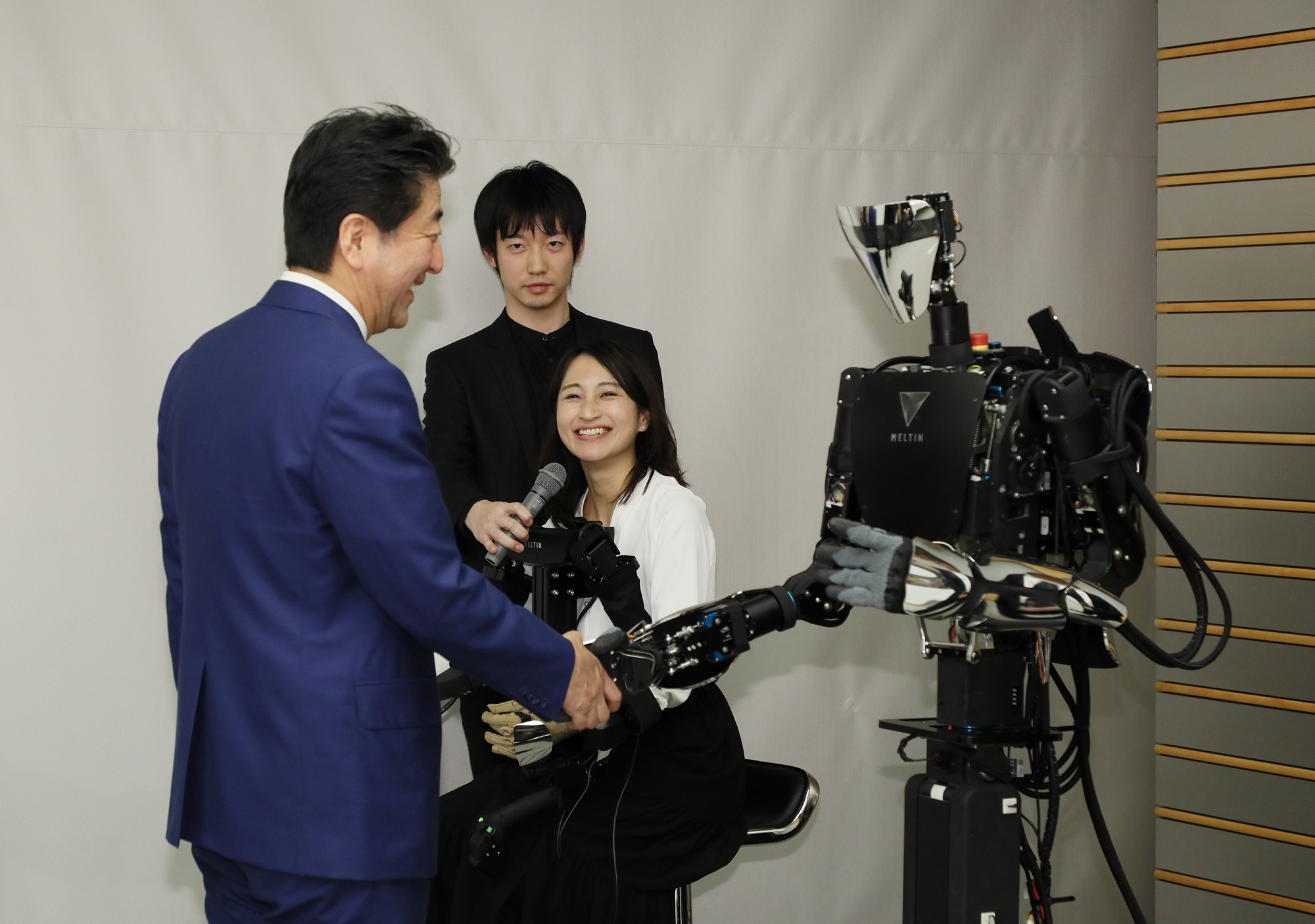 Photograph of the Prime Minister shaking hands with a robot