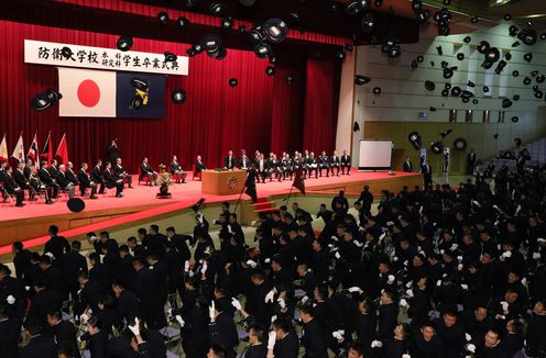 Photograph of the Prime Minister looking over the graduates