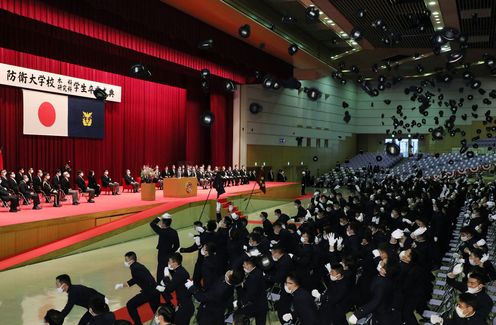 Photograph of the Prime Minister looking over the graduates