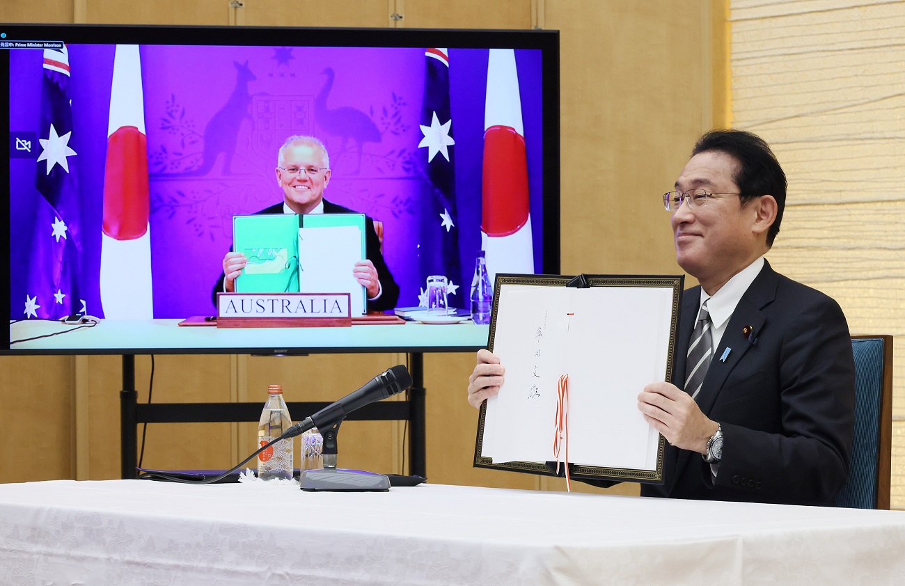 Photograph  of the Prime Minister holding up a signed document (1)