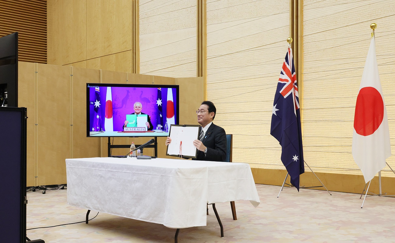 Photograph  of the Prime Minister holding up a signed document (3)