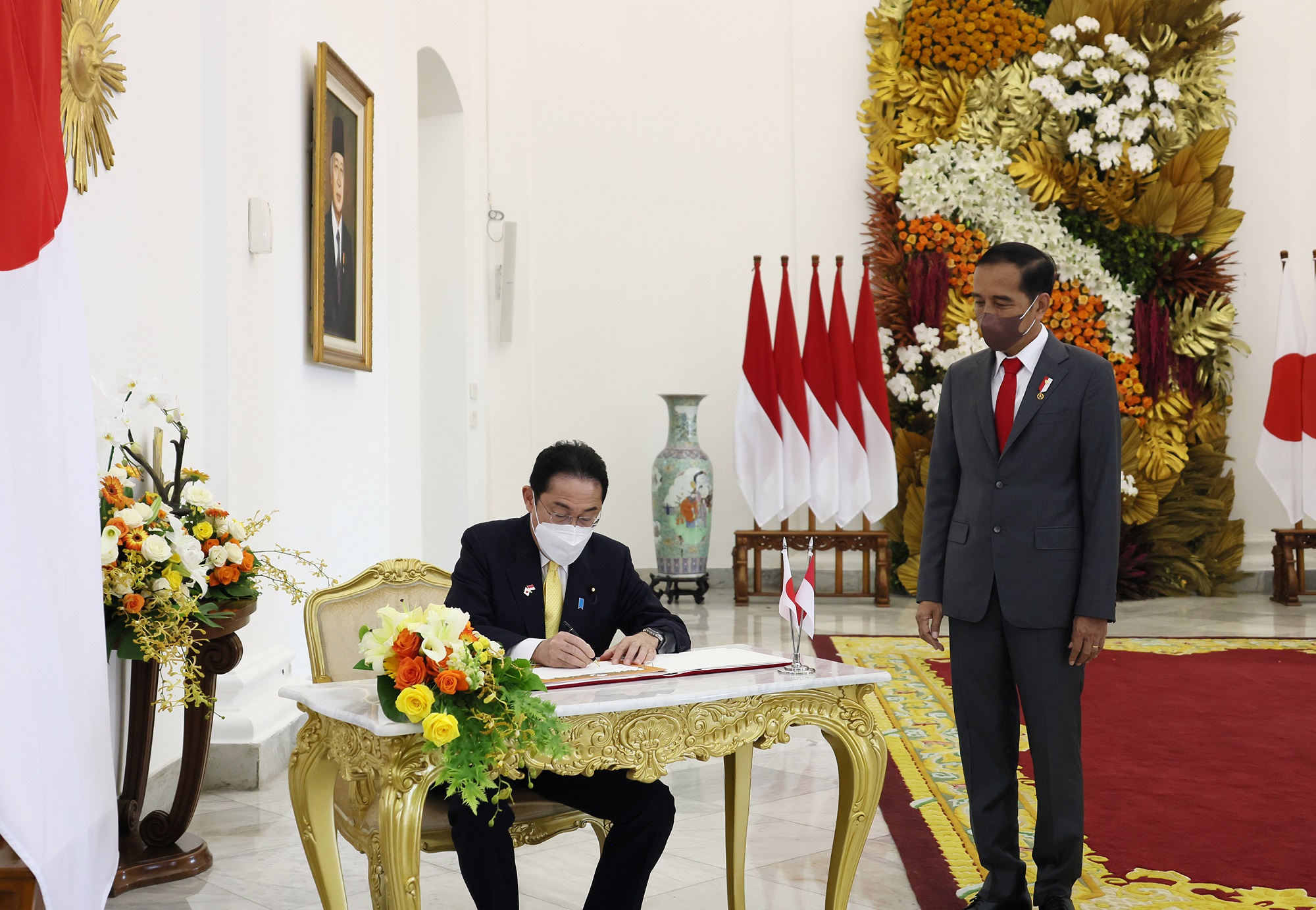 Photograph of the Prime Minister signing a visitors' book