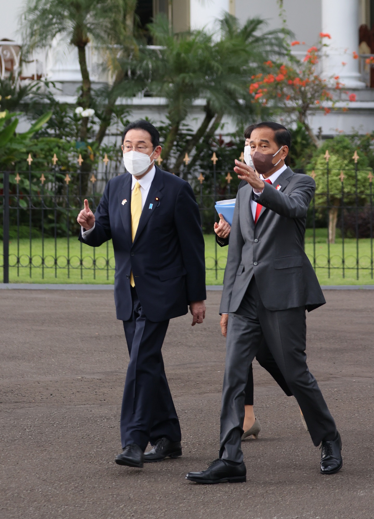 Photograph of the two leaders heading to a tree planting ceremony
