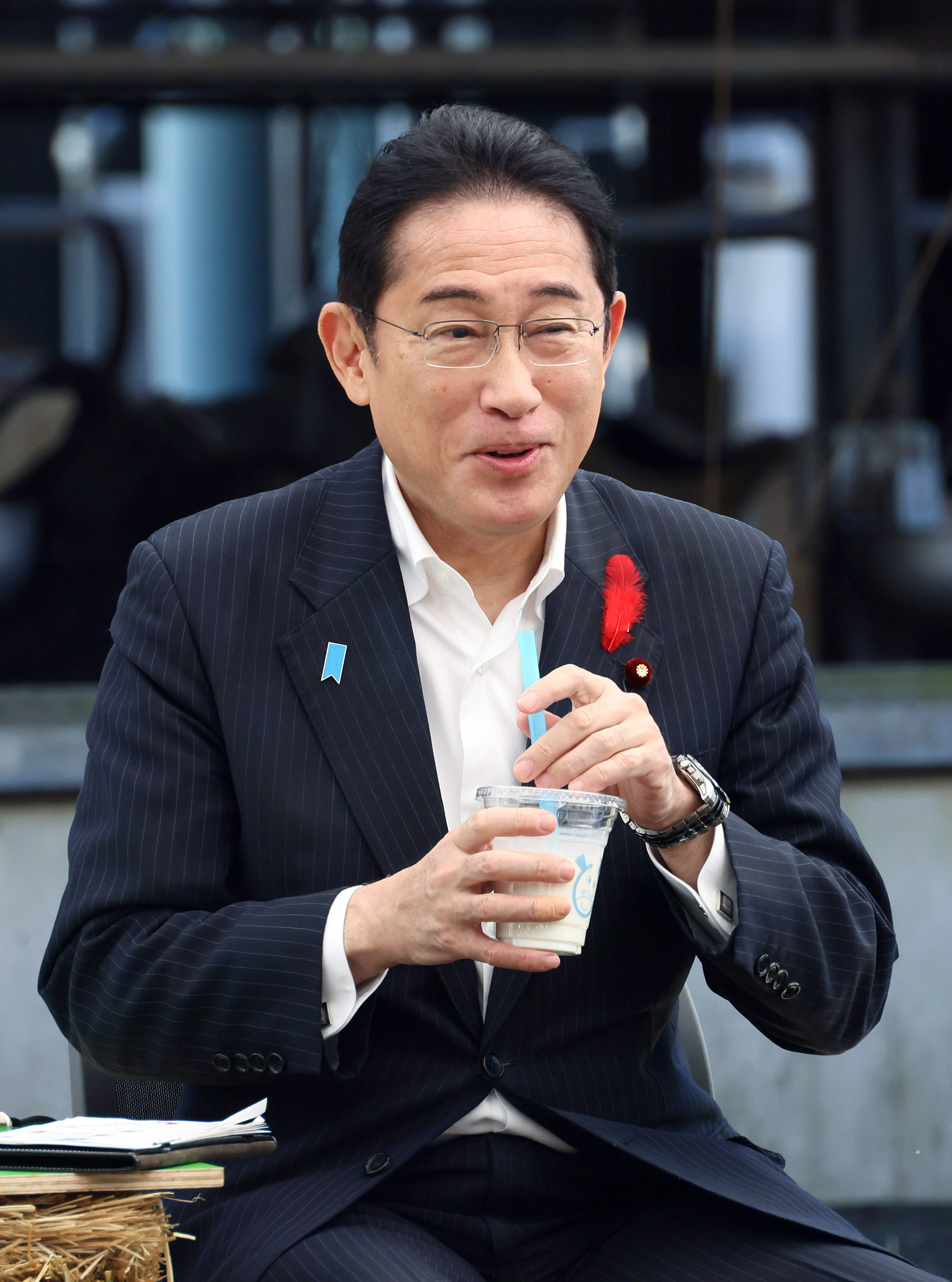 Prime Minister Kishida tasting a cup of milk