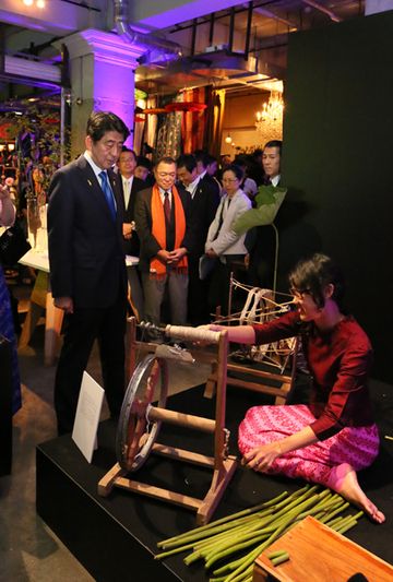 Photograph of the Prime Minister observing a demonstration of traditional thread spinning
