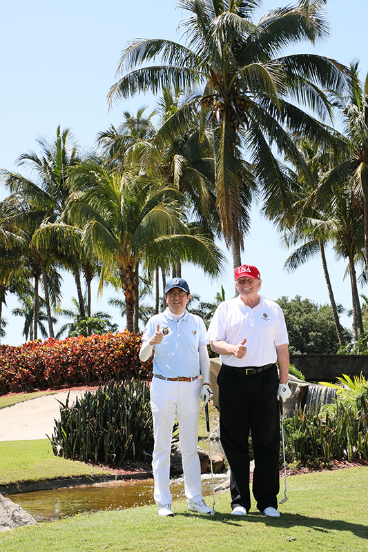 Photograph of the leaders playing golf